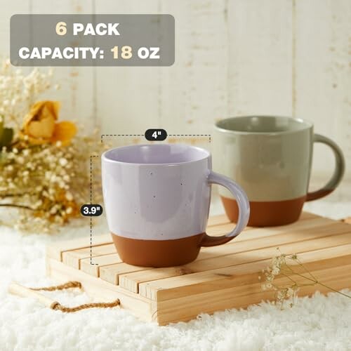 Two ceramic mugs on a wooden tray with flowers, labeled 6 pack, capacity 18 oz.