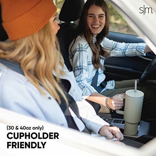 Two people in a car with a cupholder-friendly tumbler.